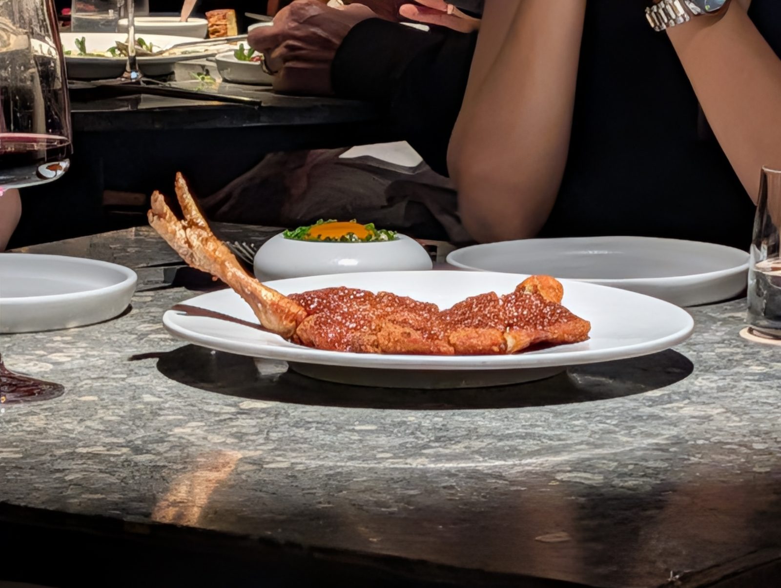 The chicken. A fillet with the leg bone standing up, so you know it was a whole bird an hour ago.