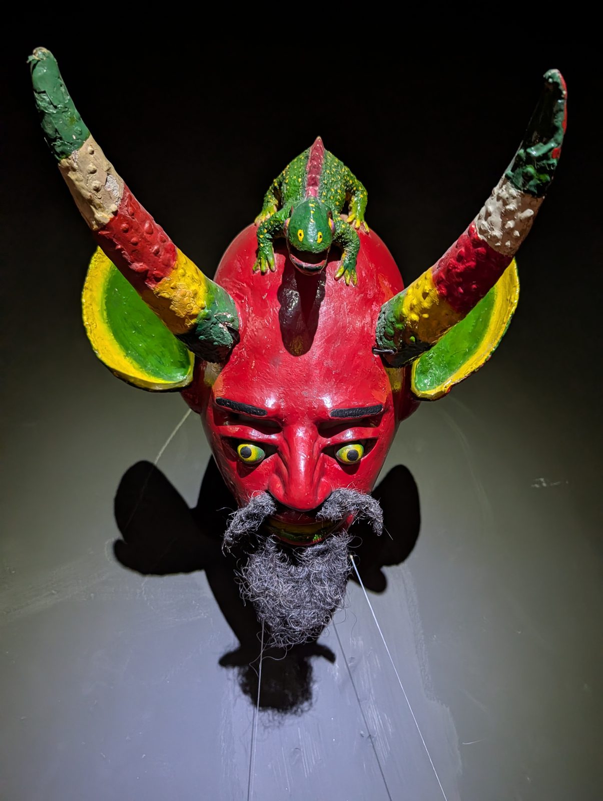 A red devil with a lizard on its forehead.