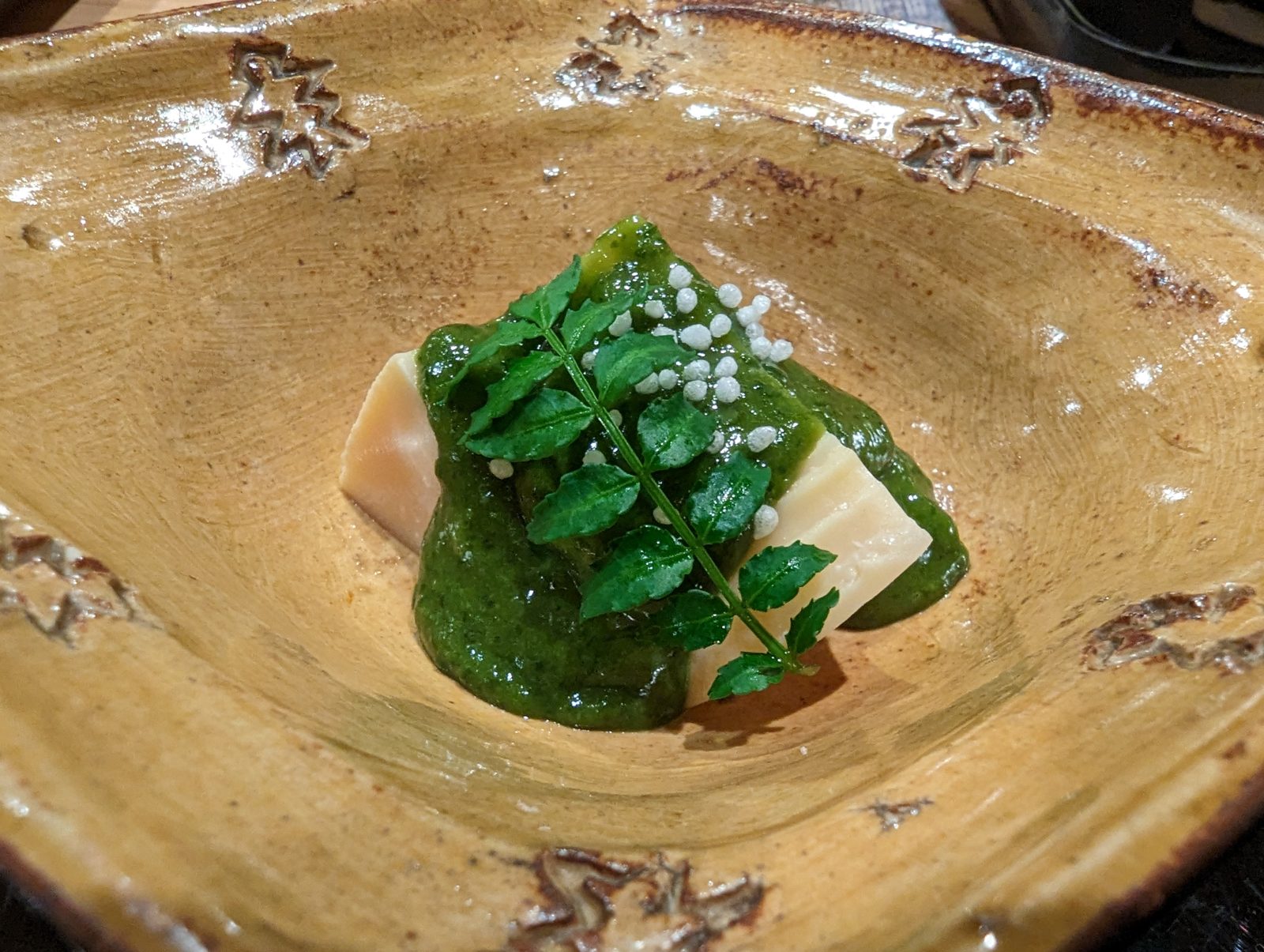 Tofu with a green sauce.