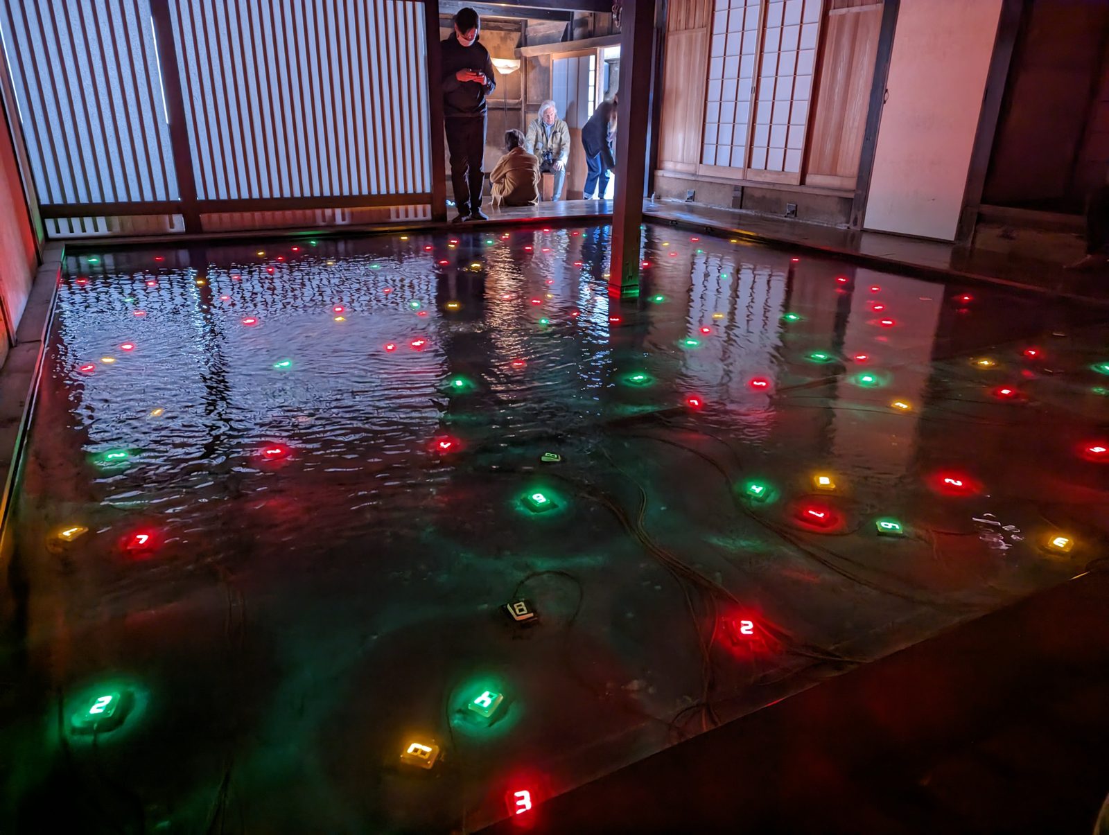 Kadoya. Tatsuo Miyajima's Sea of Time: LED counters under water, each one set to a different speed by a villager.